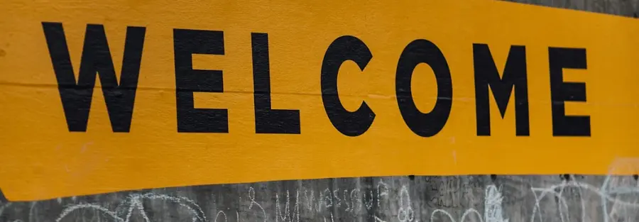 graffiti on a cement wall that says "everyone is welcome"