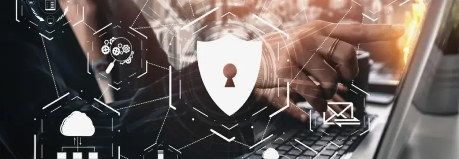 a person typing and pointing at their computer with cyber security logos in the foreground