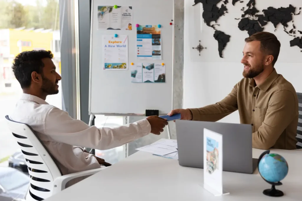 Immigration consultant handing documents to applicant for Canada Atlantic Immigration Pilot Program